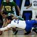 Pioneer senior Ethan Luke Spencer and Huron junior Chris Mosley dive for a loose ball on Friday, Jan. 18. Daniel Brenner I AnnArbor.com
